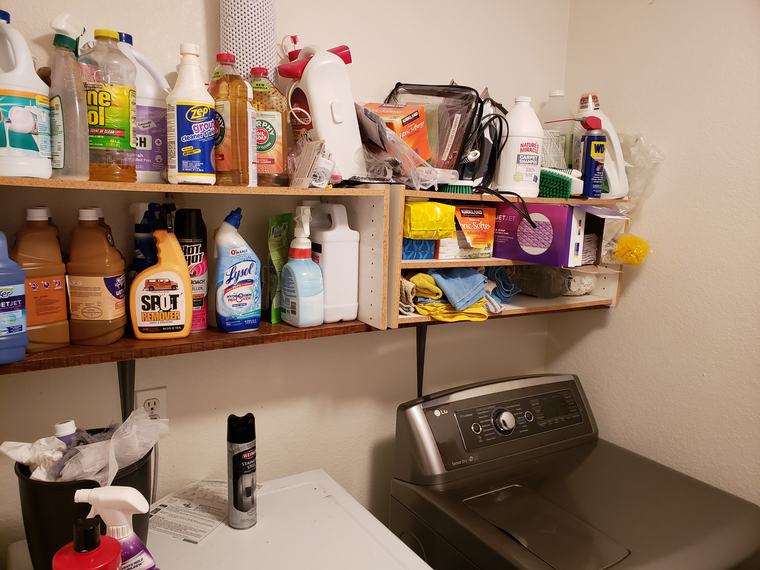 Cluttered mismatched laundry room shelving packed with bottles